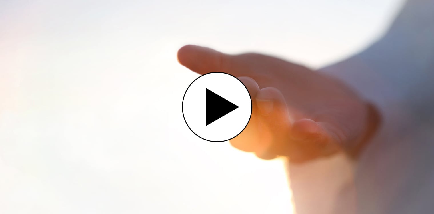 A hand reaching out with clouds in the background
